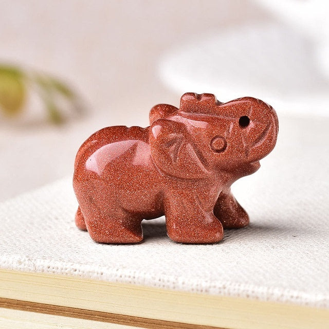 Healing crystal elephant stone carved from shiny reddish brown gemstone by Sacred Moon Candle Co