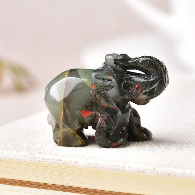 Healing crystal elephant stone carved with green and red accents from Sacred Moon Candle Co